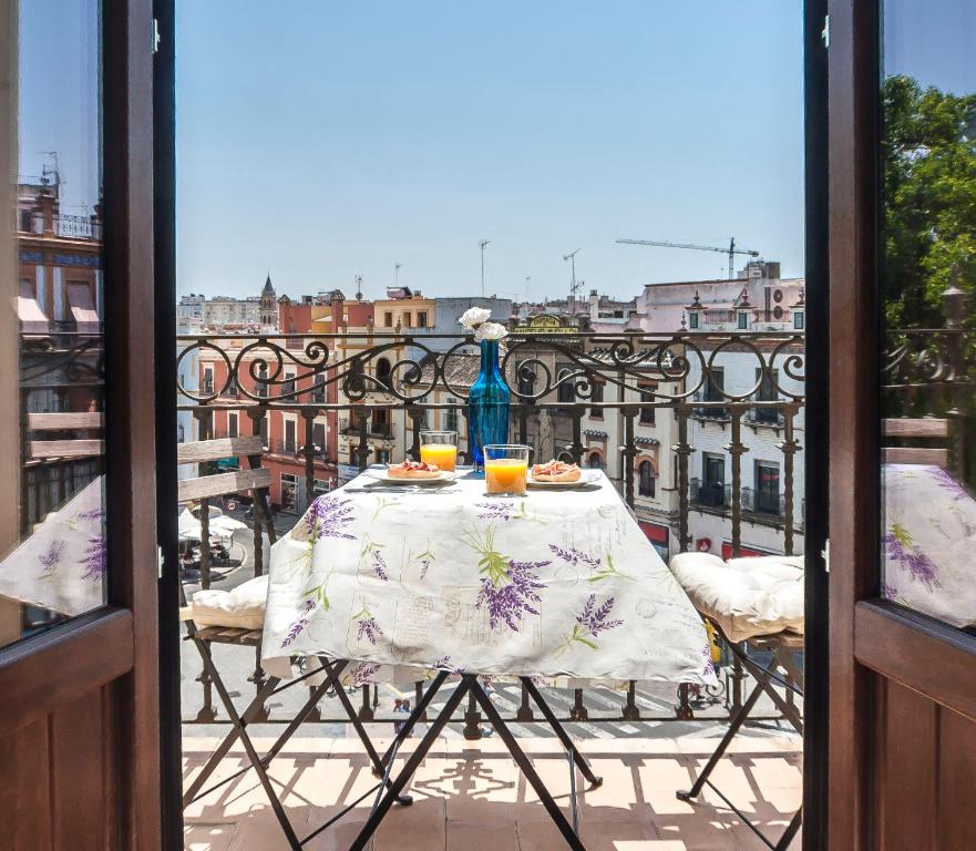 a table on a balcony with a view of a city at Triana Sky View by Valcambre in Seville