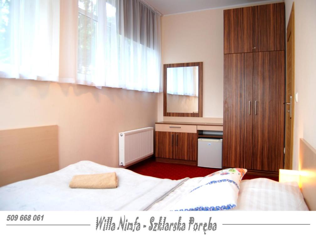 Posteľ alebo postele v izbe v ubytovaní Willa Nimfa pokoje i apartamenty, również cała willa na wyłączność