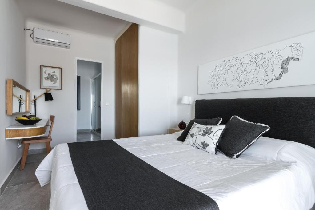 Postel nebo postele na pokoji v ubytování Amaze Suites