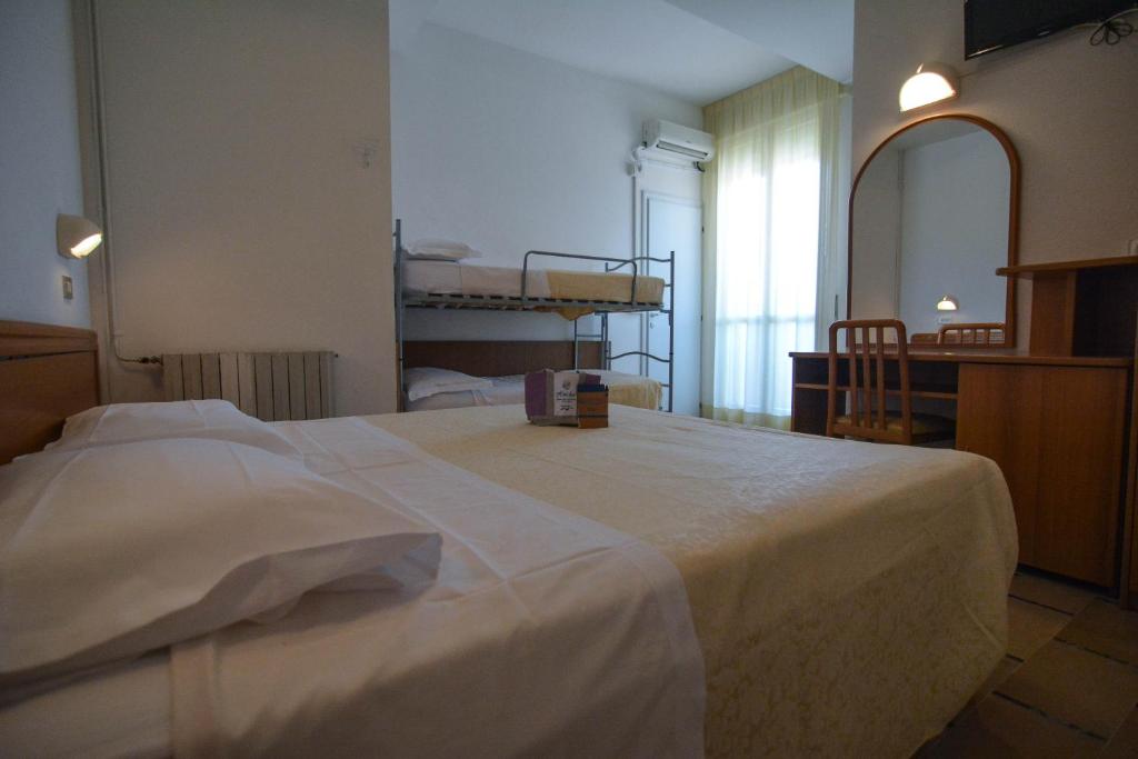 Postel nebo postele na pokoji v ubytování Hotel Zani