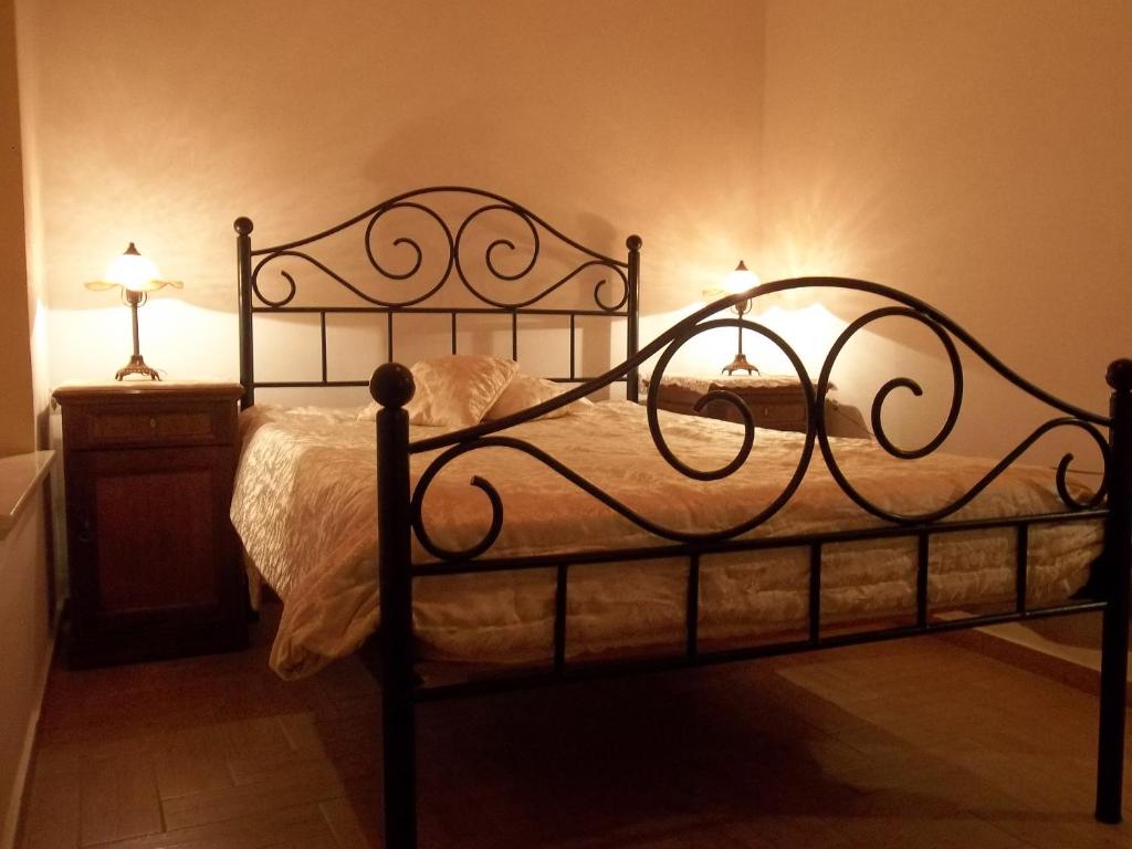 a bedroom with a black bed with lights on it at Villa 1930 first floor in Vóroi