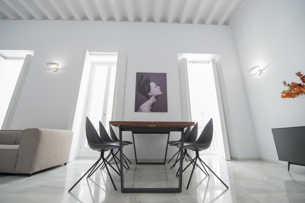 a dining room with a table and chairs at Casa Columela Cadiz in Cádiz