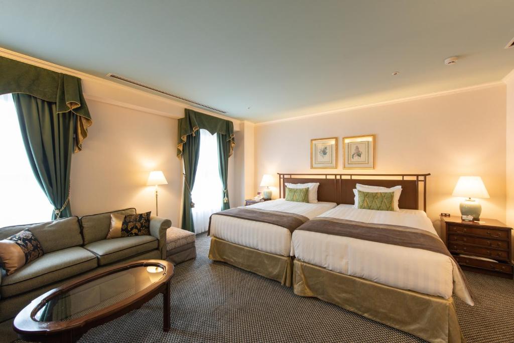 Postel nebo postele na pokoji v ubytování Kobe Kitano Hotel