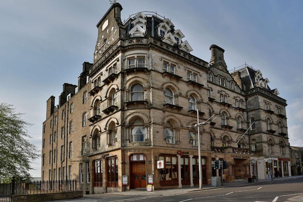 a large building with a clock on top of it at Best Western Queens Hotel in Dundee