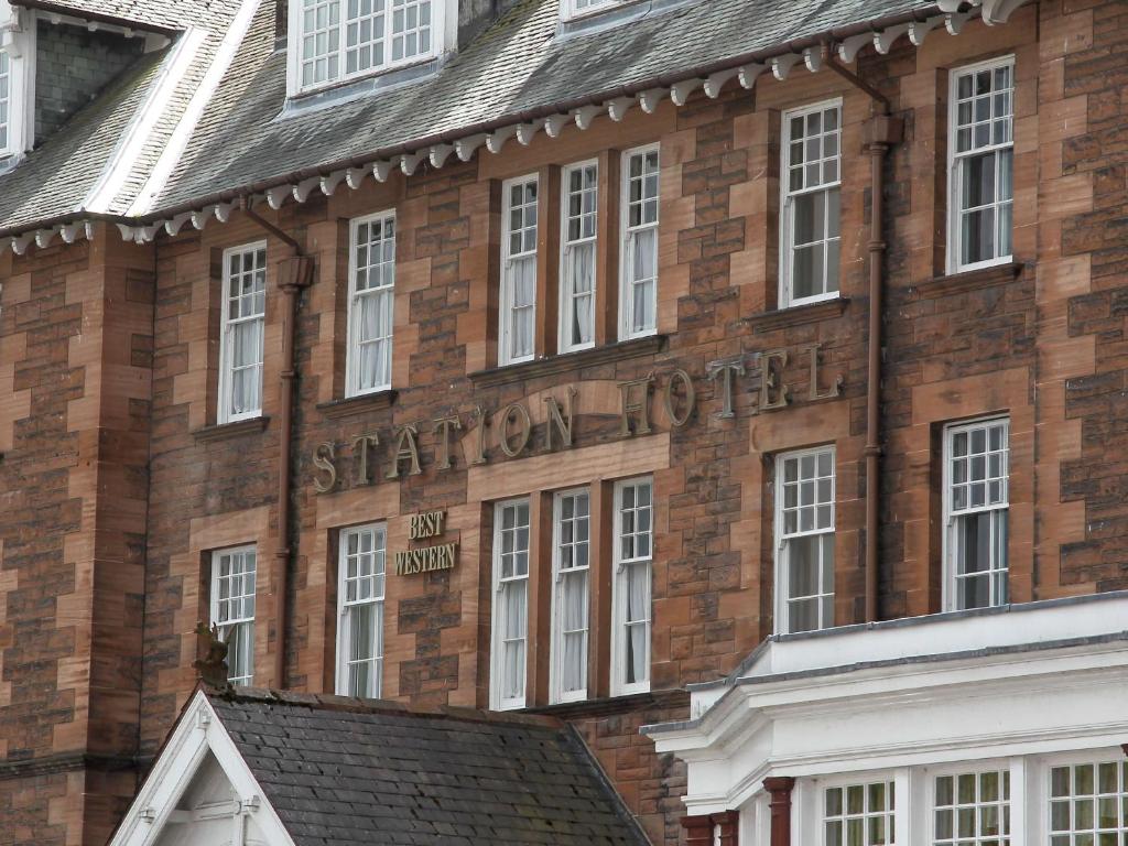 a brick building with a sign on the side of it at Best Western Station Hotel in Dumfries