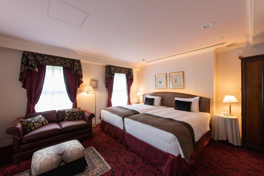 Postel nebo postele na pokoji v ubytování Kobe Kitano Hotel