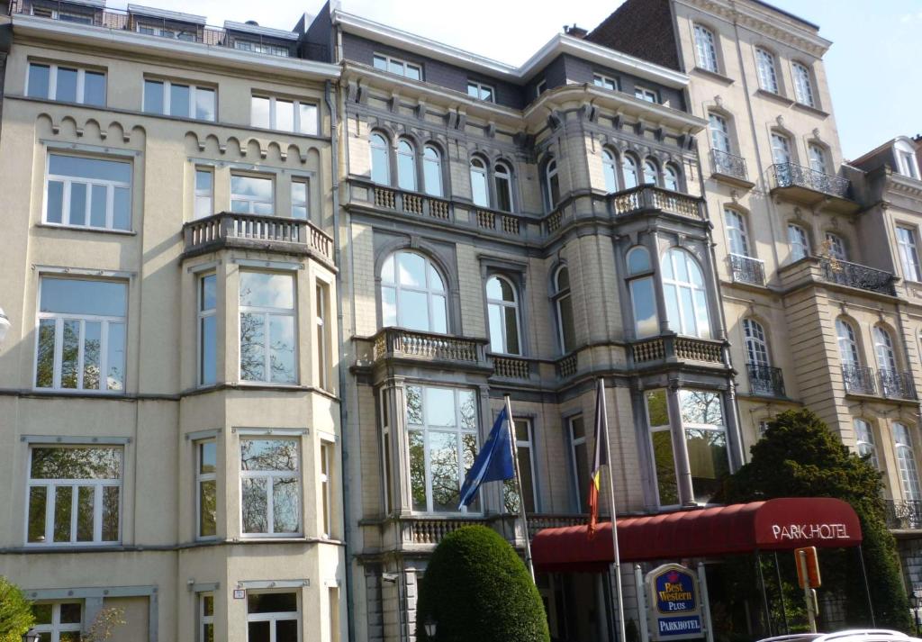 a large building with a clock on the front of it at Best Western Plus Park Hotel Brussels in Brussels