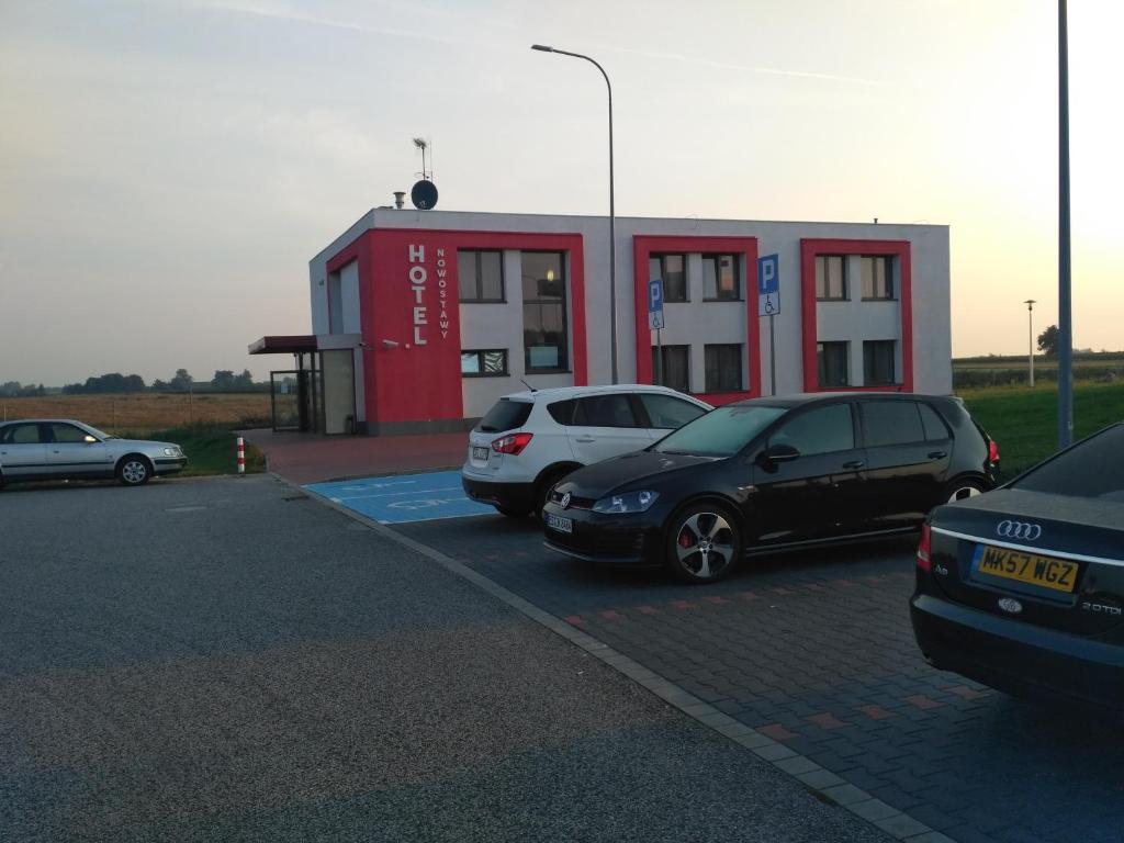 a parking lot with cars parked in front of a gas station at Hotel Nowostawy A2 MOP in Nowostawy Dolne