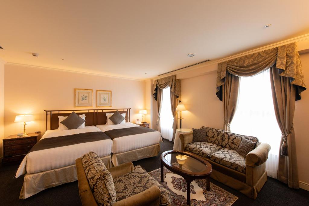 Postel nebo postele na pokoji v ubytování Kobe Kitano Hotel