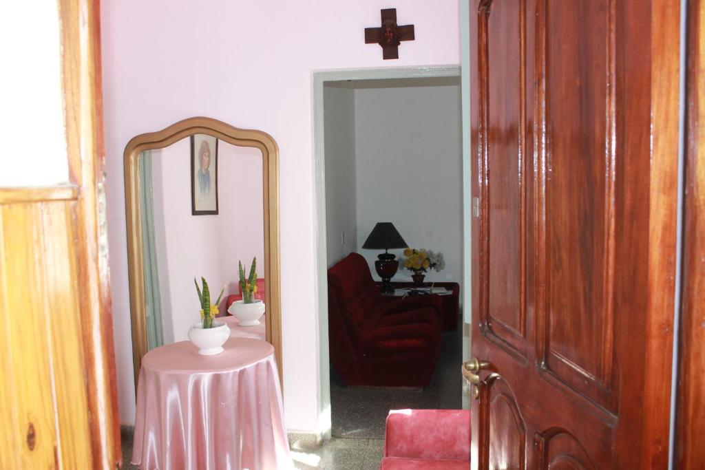 a hallway with a mirror and a table and a chair at Tres Marias in San Juan