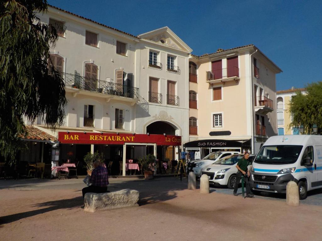 een gebouw met een busje voor een straat bij apart Port Grimaud Marché in Grimaud