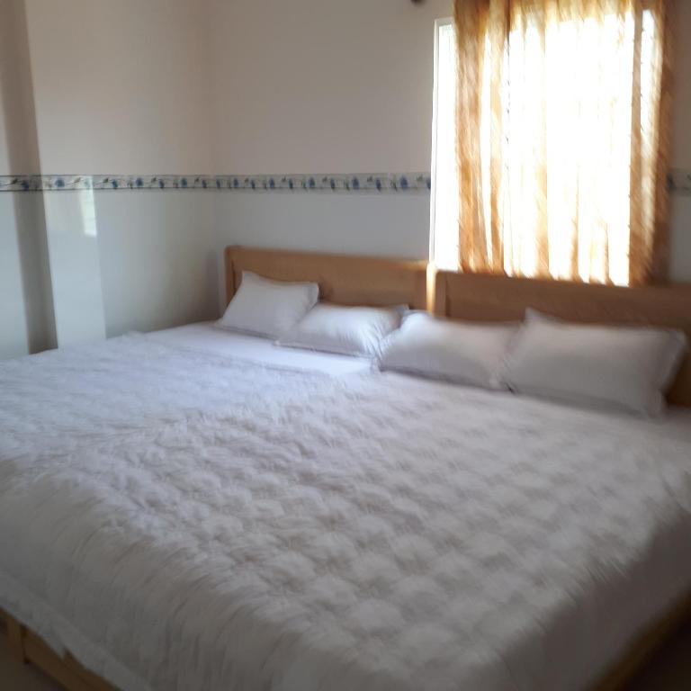 Postel nebo postele na pokoji v ubytování Cao Hung Hotel