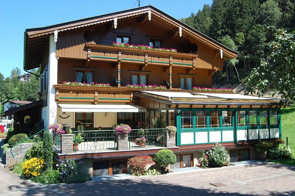 a large house with flowers on the balcony at Gästehaus Waldruh in Mayrhofen