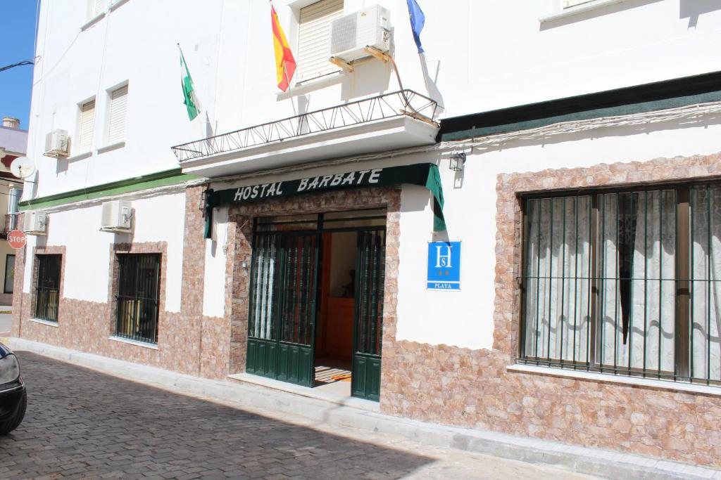 a building with a sign on the front of it at Hostal Barbate in Barbate