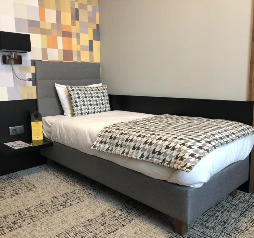 Postel nebo postele na pokoji v ubytování IBB Hotel Gdańsk