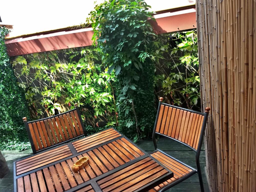 two benches sitting next to each other on a patio at Domik u Plyazha Guest House in Gelendzhik