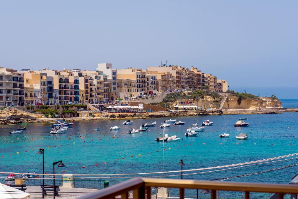 a group of boats in the water in a harbor at Electra Guesthouse in Marsalforn