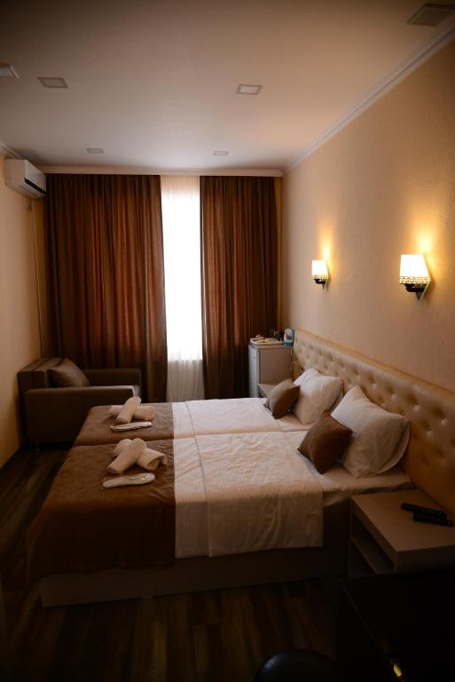 Postel nebo postele na pokoji v ubytování Hotel New Avlabari