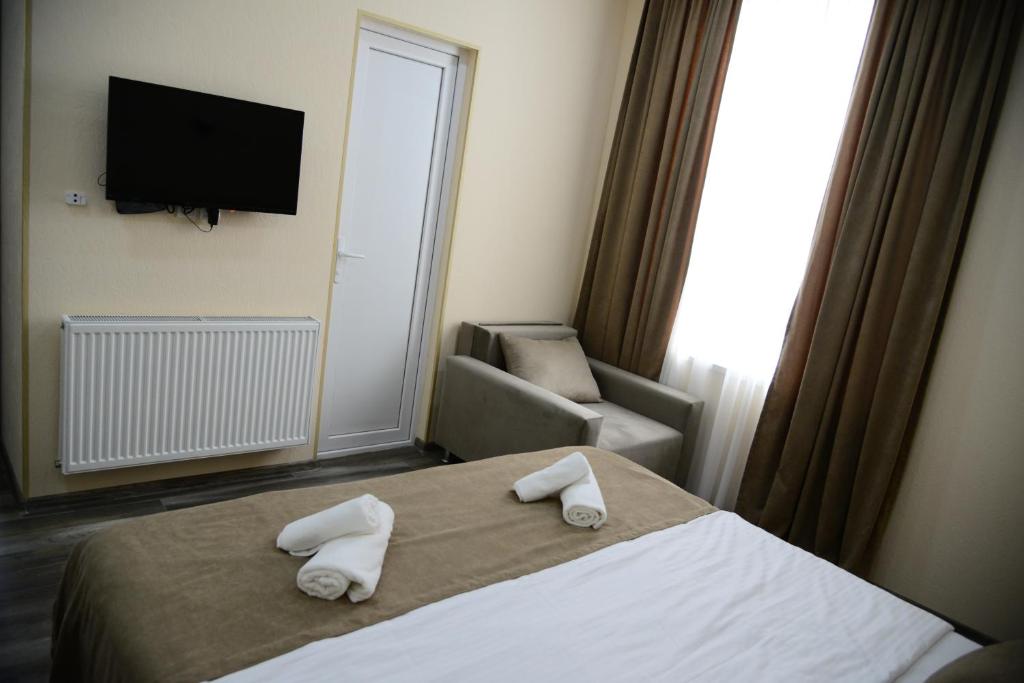 Postel nebo postele na pokoji v ubytování Hotel New Avlabari