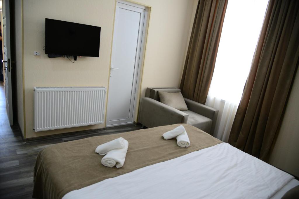 Postel nebo postele na pokoji v ubytování Hotel New Avlabari