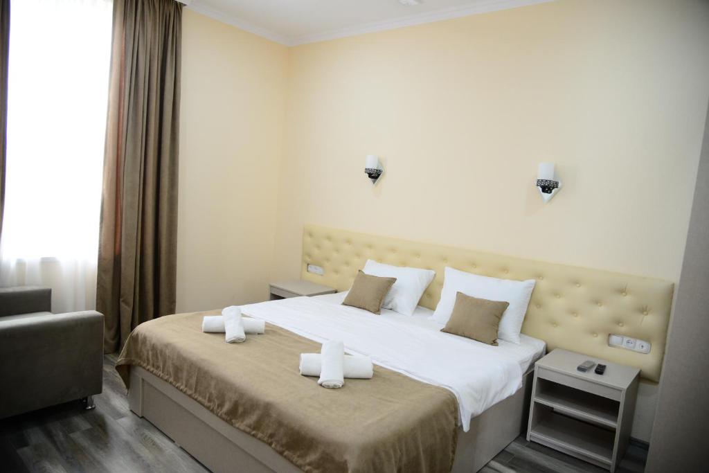 Postel nebo postele na pokoji v ubytování Hotel New Avlabari