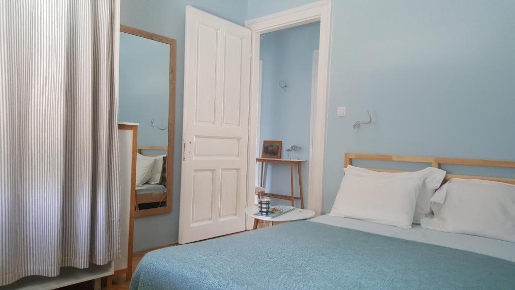 a bedroom with a blue bed and a mirror at Room next to Porto Montenegro in Tivat