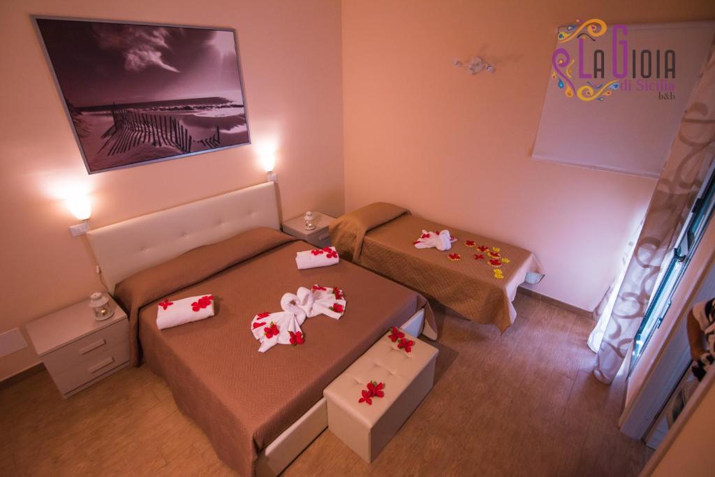Postel nebo postele na pokoji v ubytování La Gioia di Sicilia B&B