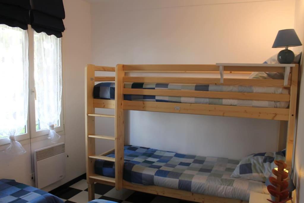 a bedroom with two bunk beds and a television at Birchbank Cottage in Coulommiers