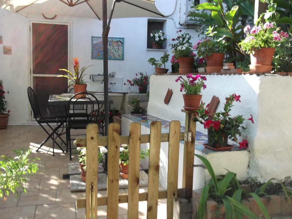 a wooden fence in front of a patio with potted plants at Le Mimose in Vietri sul Mare