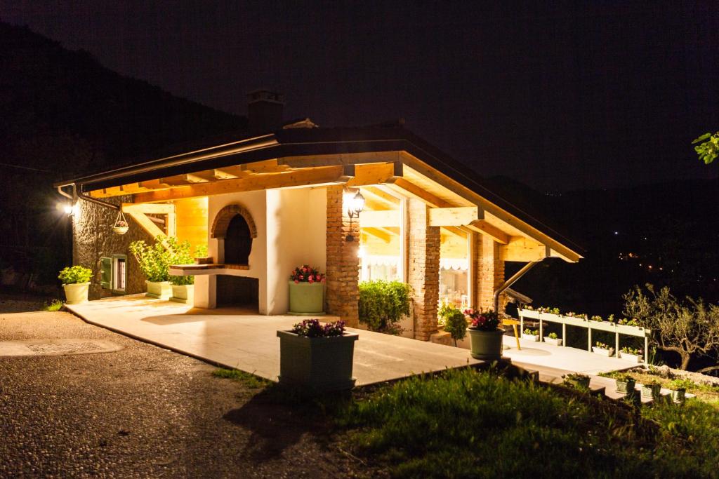 a small house with a porch at night at Agriturismo Caranatura in Novaglie
