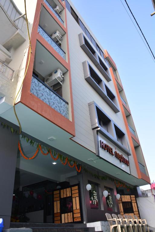 a building with a hotel in front of it at Hotel neptune in Amreli