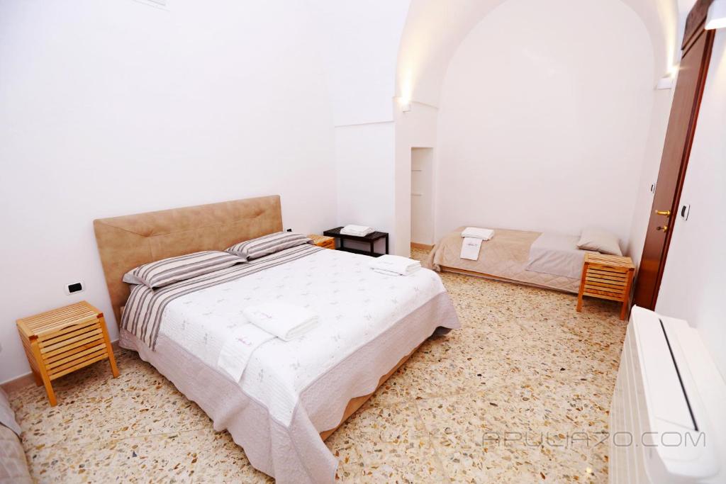 Postel nebo postele na pokoji v ubytování Apulia 70 Holidays - Suites & Experiences