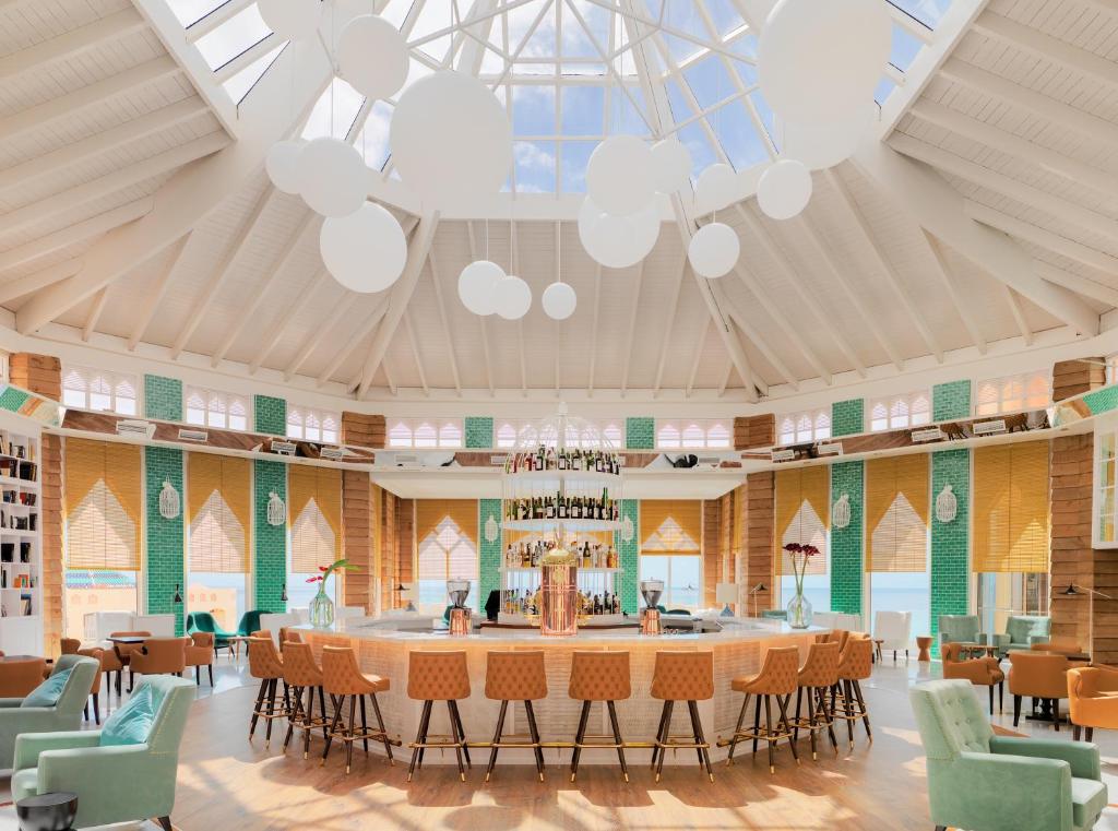 a large dining room with a large table and chairs at H10 Playa Esmeralda - Adults Only in Costa Calma