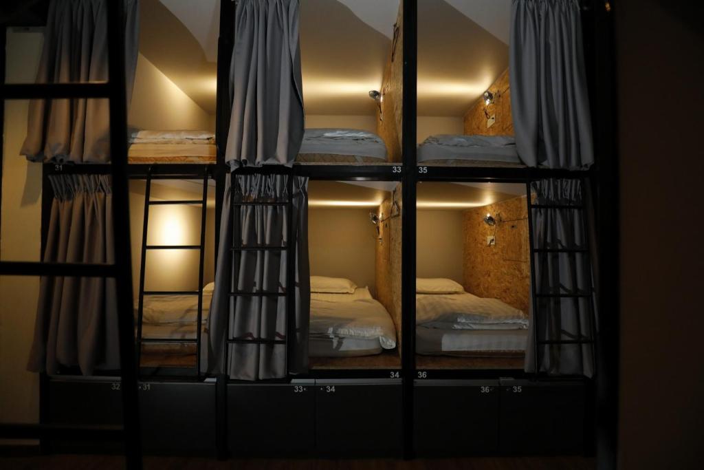 a reflection of a room with two beds in a mirror at Sleepbox Hotel in Cameron Highlands