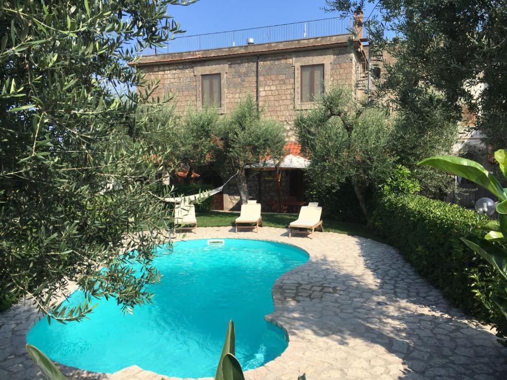 a swimming pool in the yard of a house at B&B La Quiete in Massa Lubrense