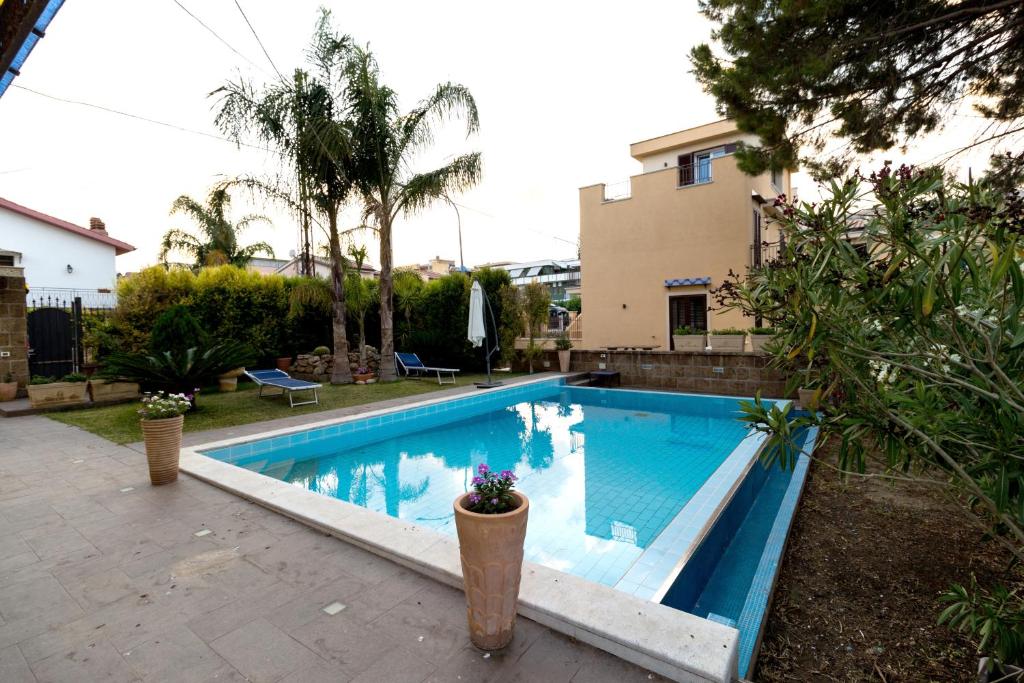 a swimming pool in the backyard of a house at ZE-VI HOME in Santa Flavia