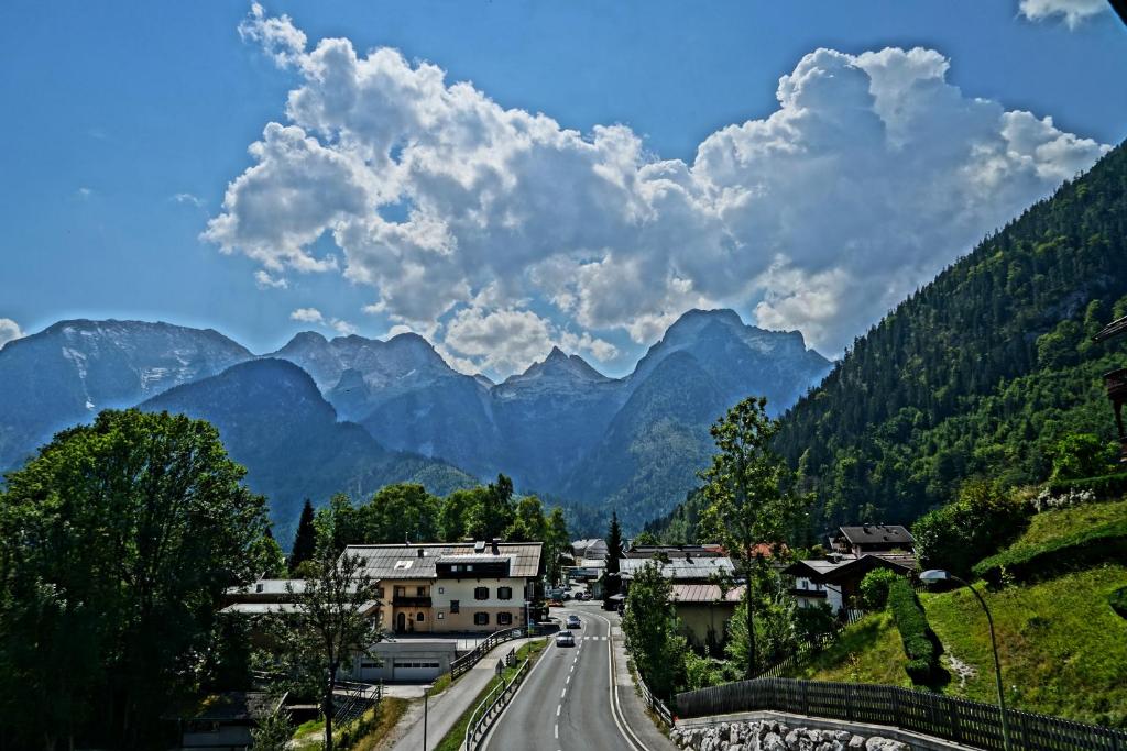 a road in a valley with mountains in the background at Pension Eckschlager in Lofer