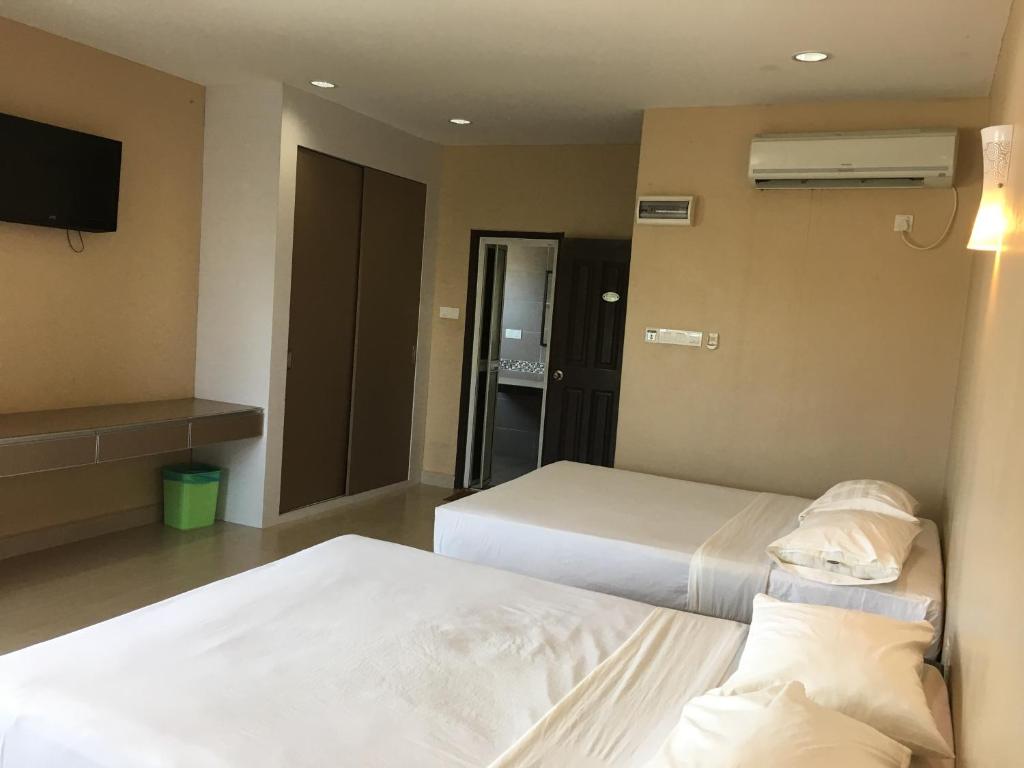 Postel nebo postele na pokoji v ubytování Pantai GuestHouse