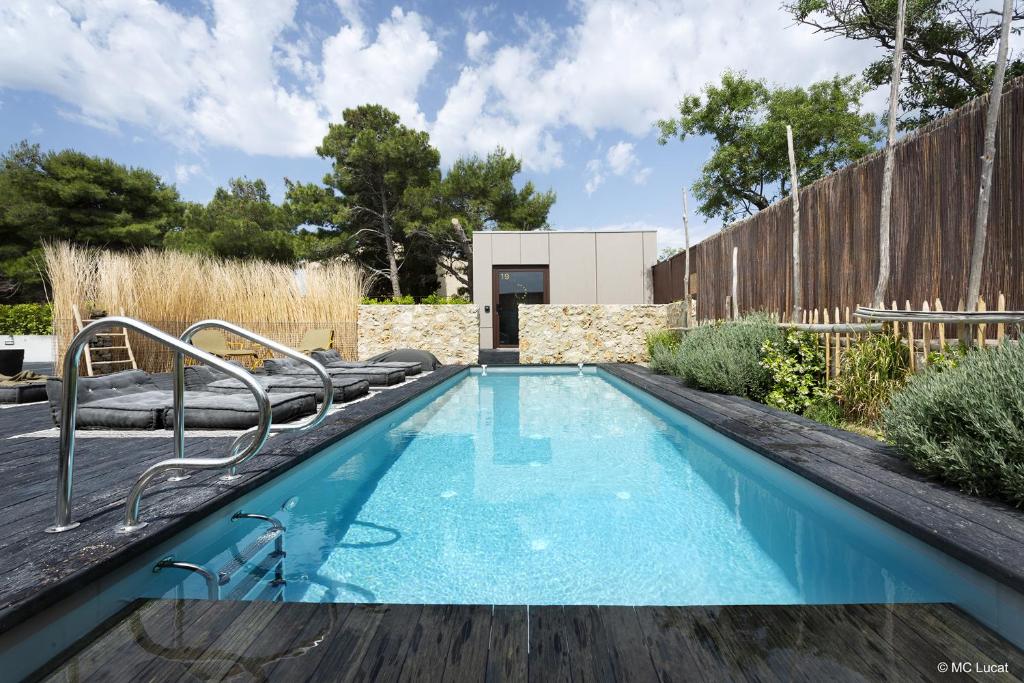 a swimming pool in the backyard of a house at Le 19-21 - Un amour d'hotel in Leucate