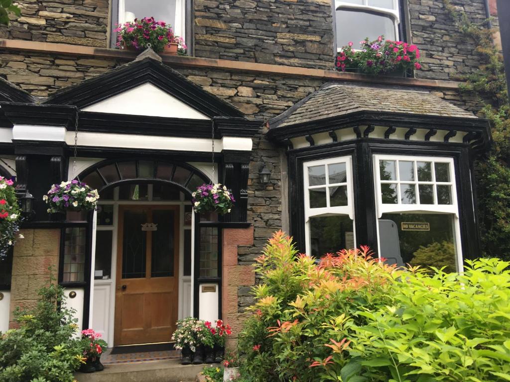 a house with flower boxes on the front door at Ivy Bank Guest House - Room Only in Windermere