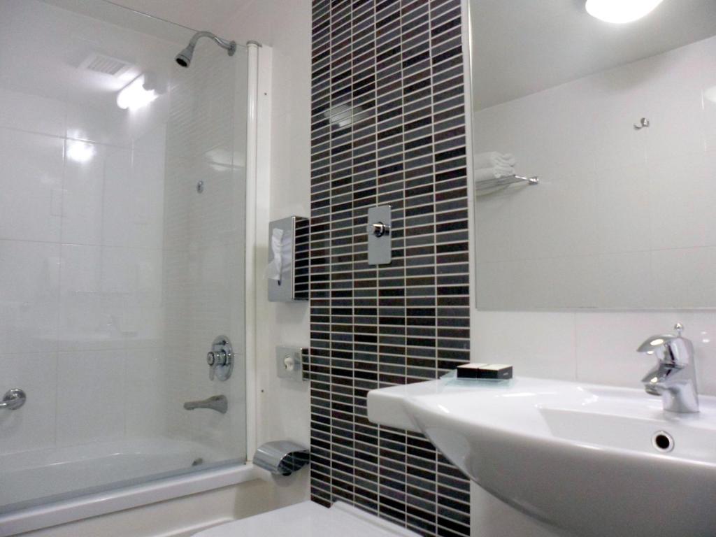 a bathroom with a sink and a shower at The Preluna Hotel in Sliema