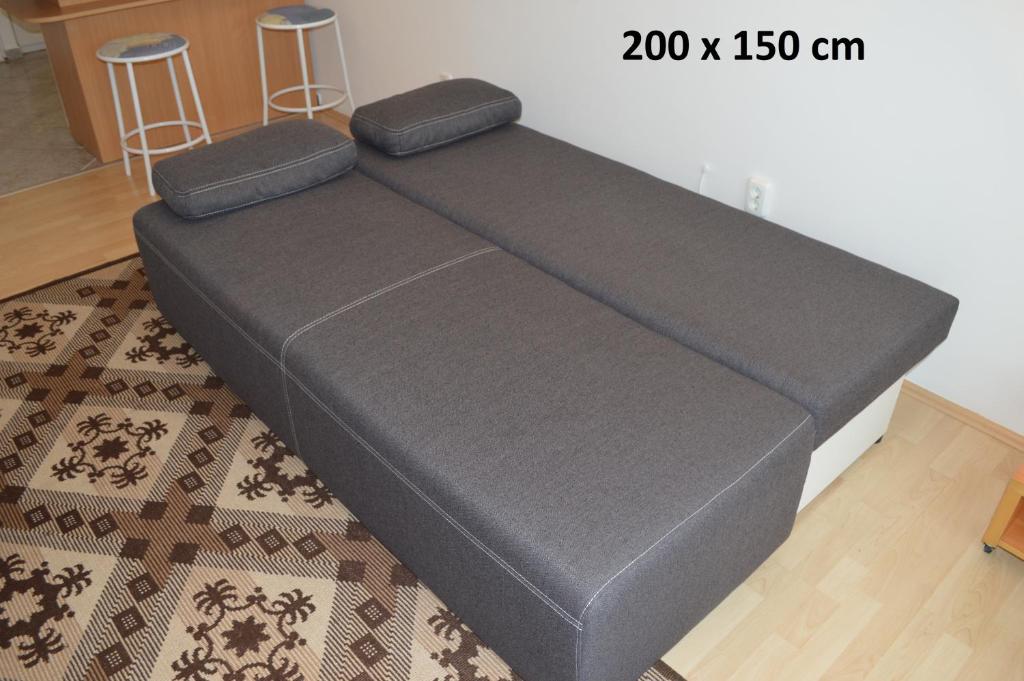 a bed frame in a room with a rug at Erdélyi vendégház in Sárospatak