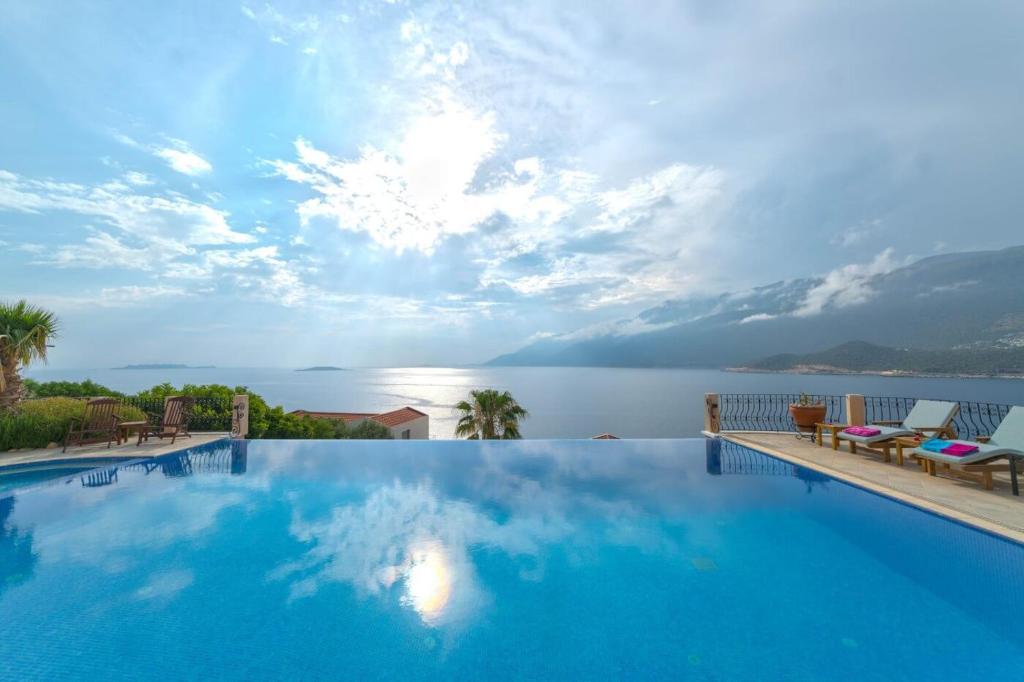 a large swimming pool with a view of the water at Villa Poseidon-in winter heated outdoor pool in Kas