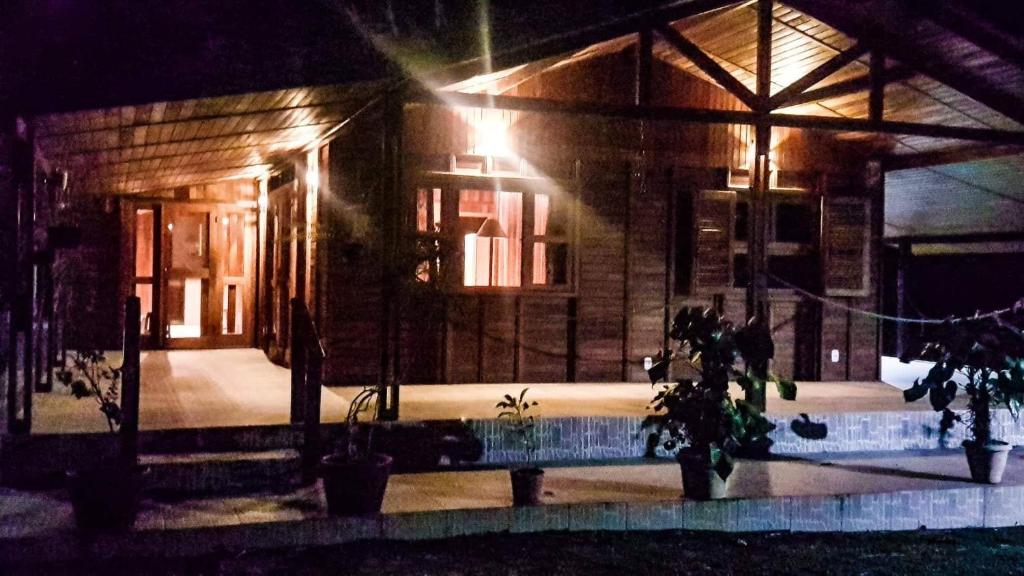a house at night with a pool in front of it at Sitio Bom Tempo in Miguel Pereira