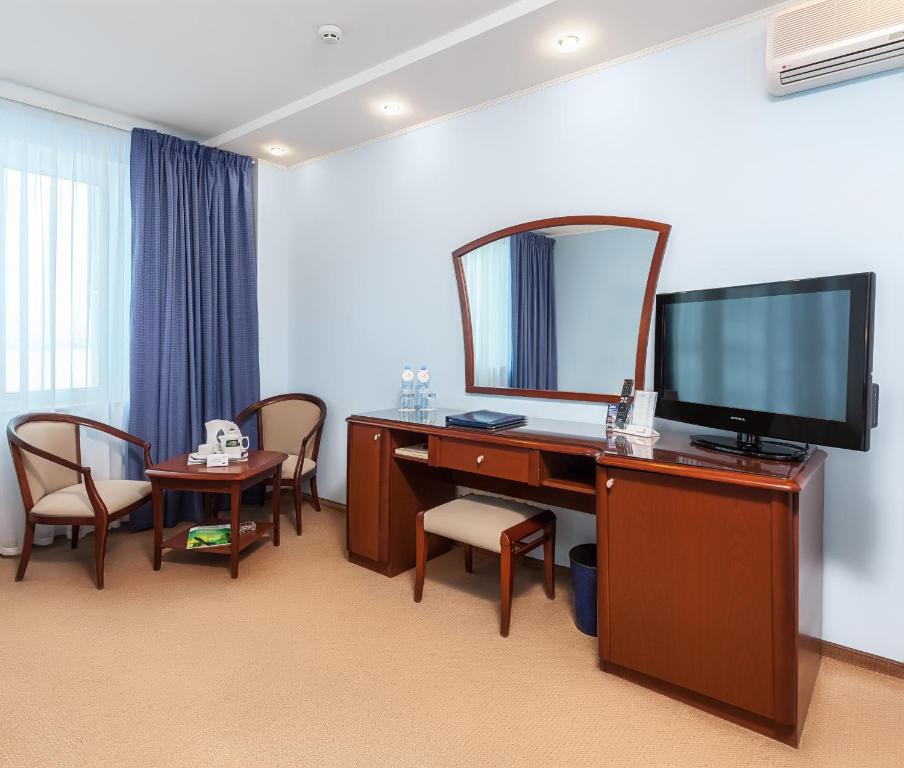 a room with a desk with a mirror and a television at Alexandrovsky Garden in Nizhny Novgorod