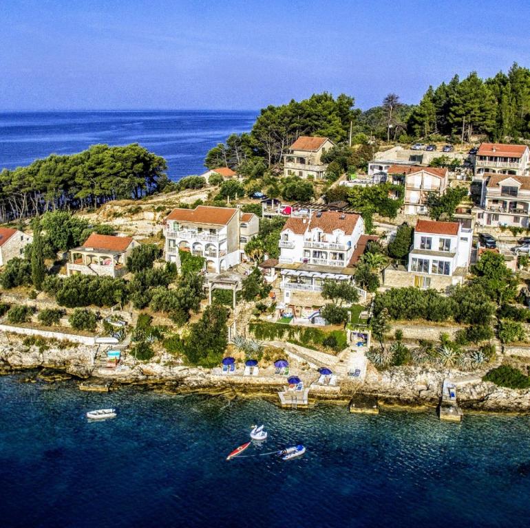 an island with houses and boats in the water at Villa Rosa in Vela Luka