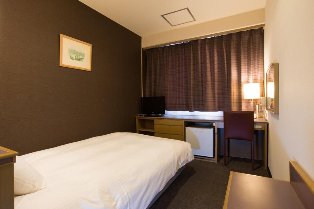 Postel nebo postele na pokoji v ubytování Hotel Suncrest