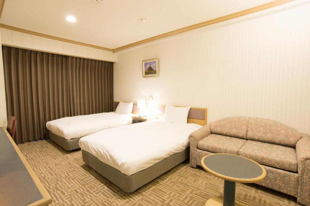 Postel nebo postele na pokoji v ubytování Hotel Suncrest
