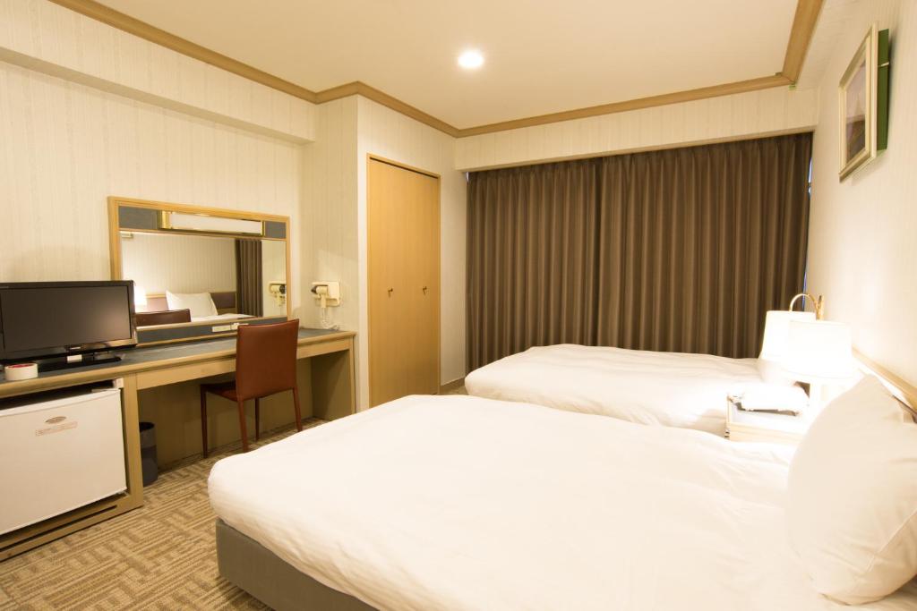Postel nebo postele na pokoji v ubytování Hotel Suncrest