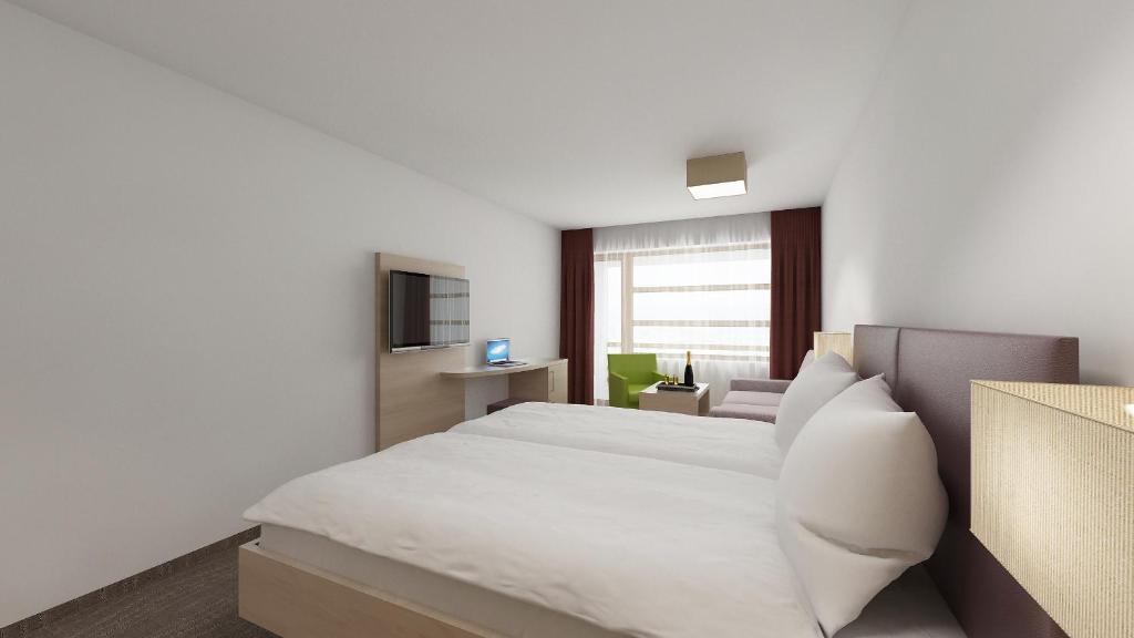 Postel nebo postele na pokoji v ubytování all inclusive Hotel Lohmann